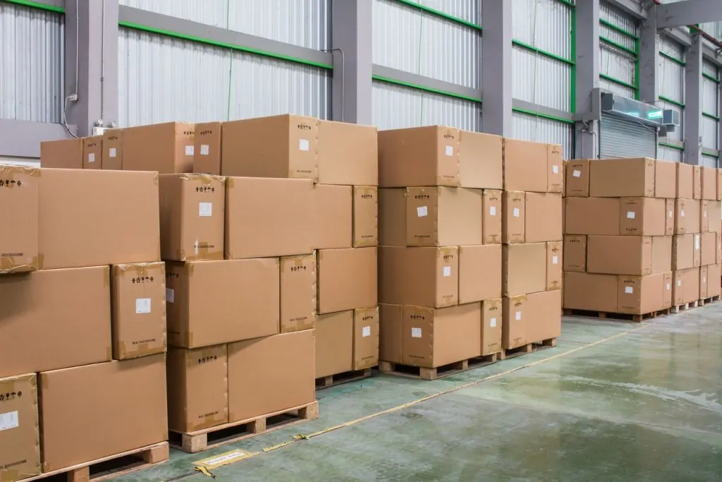 Pallets of boxed inventory stacked in a wholesale warehouse